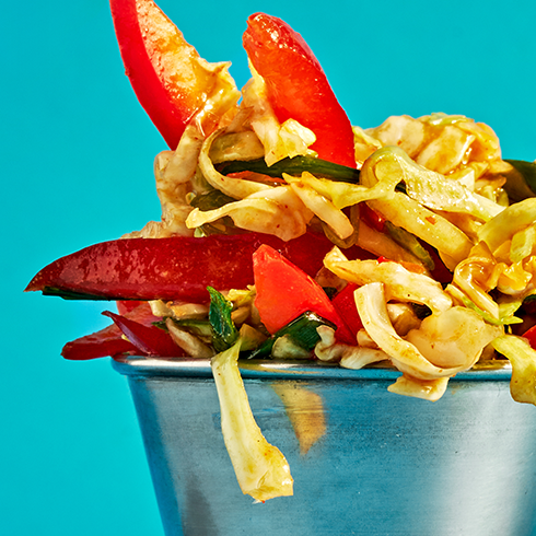 A close-up of colorful Hencraft coleslaw in a metal cup.